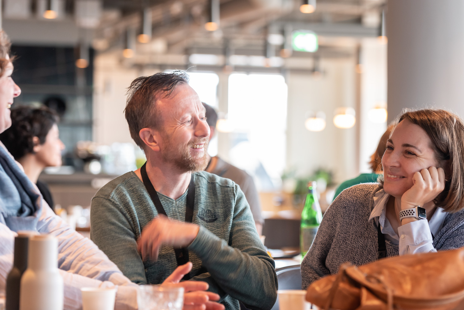 A group of attendees in conversation during a session break.
